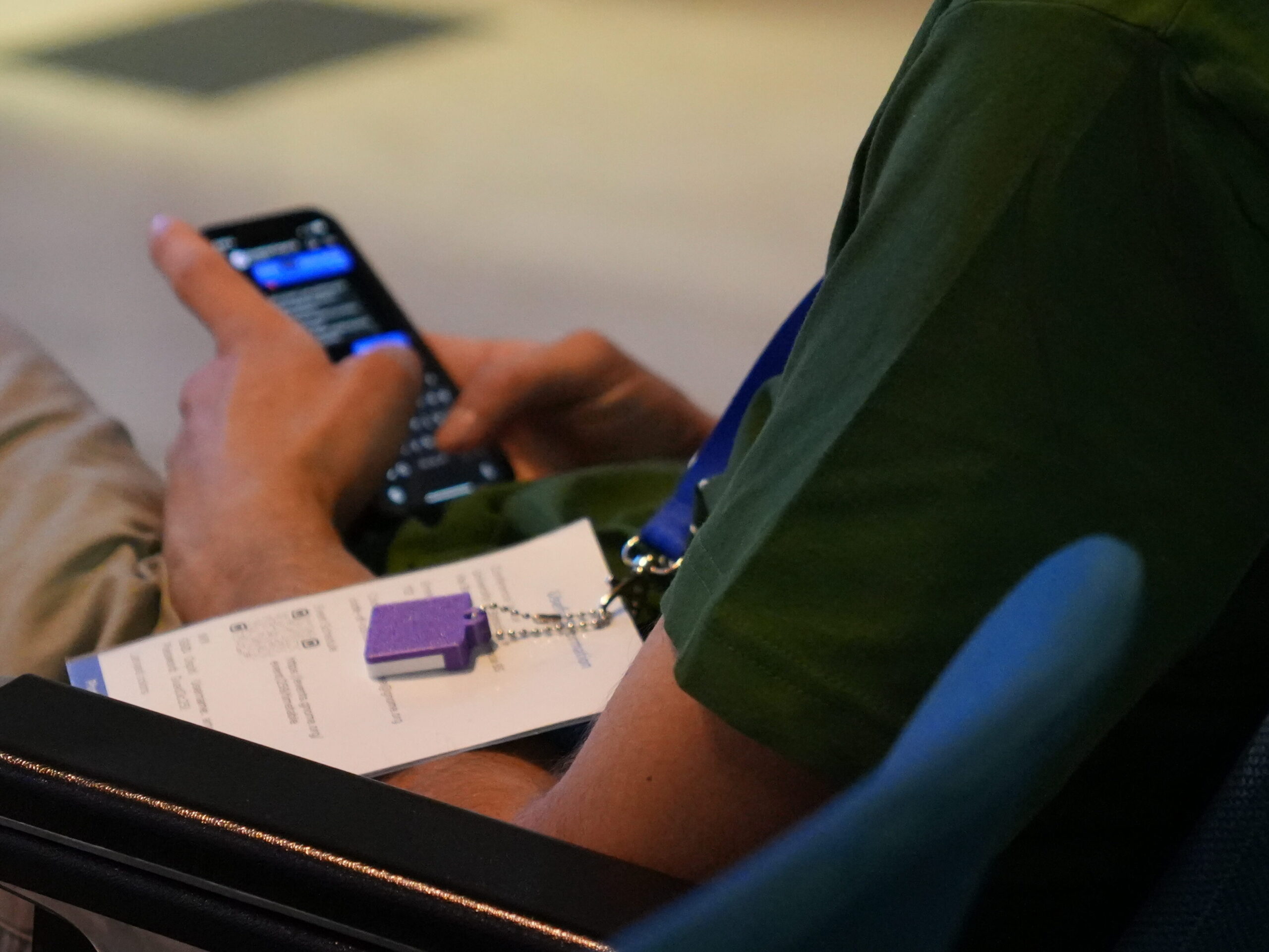 Someone using a smartphone, with a 3D printed calendar visible